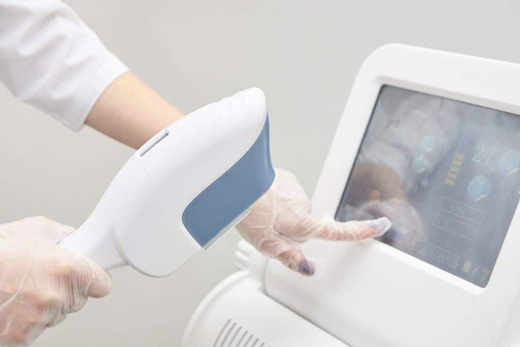 Modern equipment. Laser hair removal. Personal care. Light background.