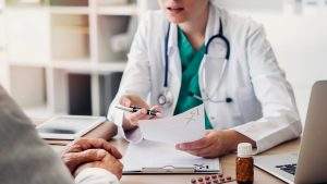 Doctor giving prescription to patient